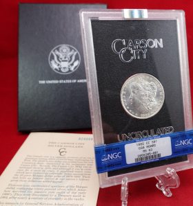A Carson City Morgan Dollar, up for auction with a red background